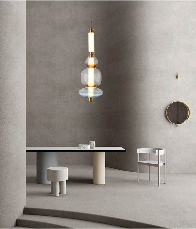 A luxurious Luna style glass pendant light with a gold and clear glass construction, designed for elegant room lighting.