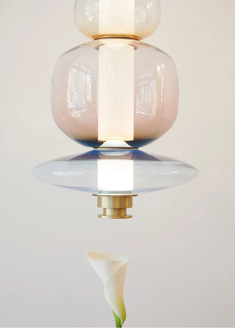 A luxurious Luna style glass pendant light with a gold and clear glass construction, designed for elegant room lighting.