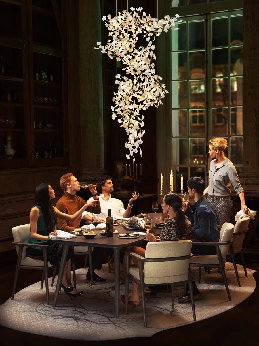 Gingko leaf chandelier above dining table in modern interior décor