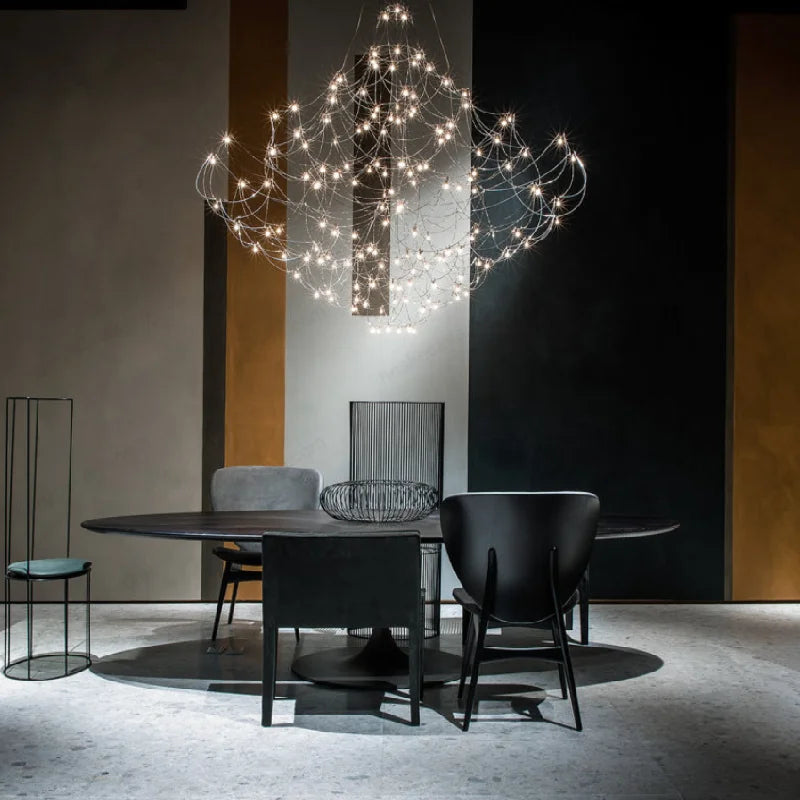 Baxter Q2 designer chandelier styled above a dining table in a modern luxury interior