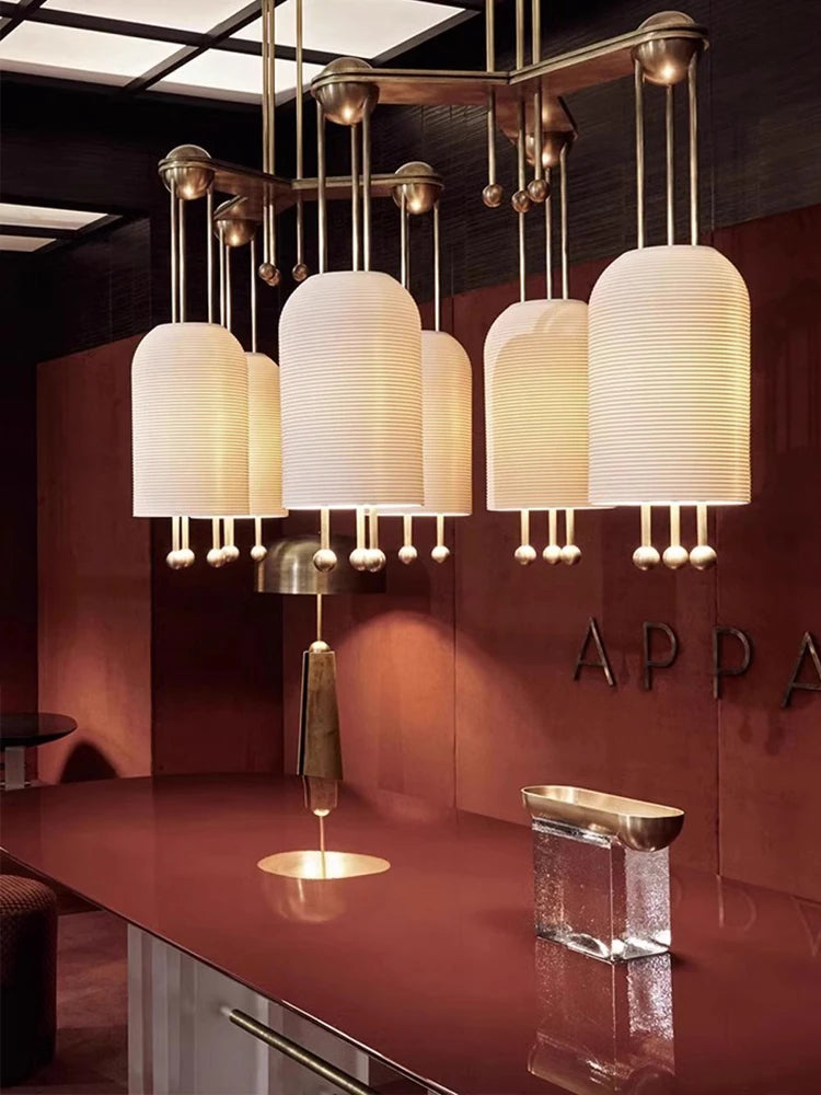 Modern chandelier with multiple lampshades in a stylish interior setting.