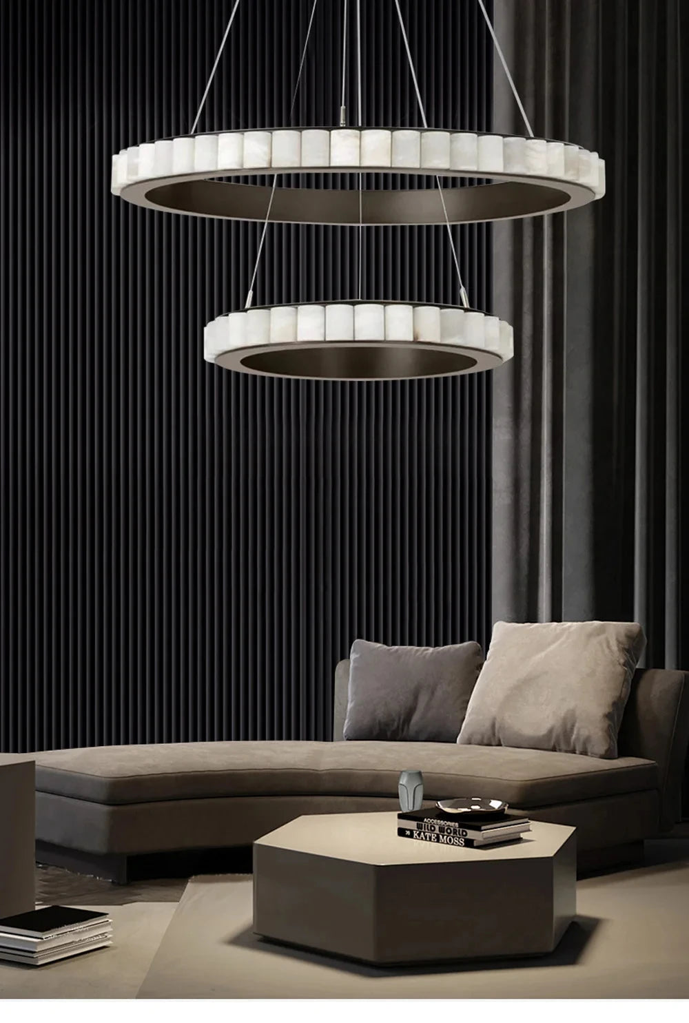 Modern living room with a gray sectional sofa, hexagonal coffee table, and two circular chandeliers.