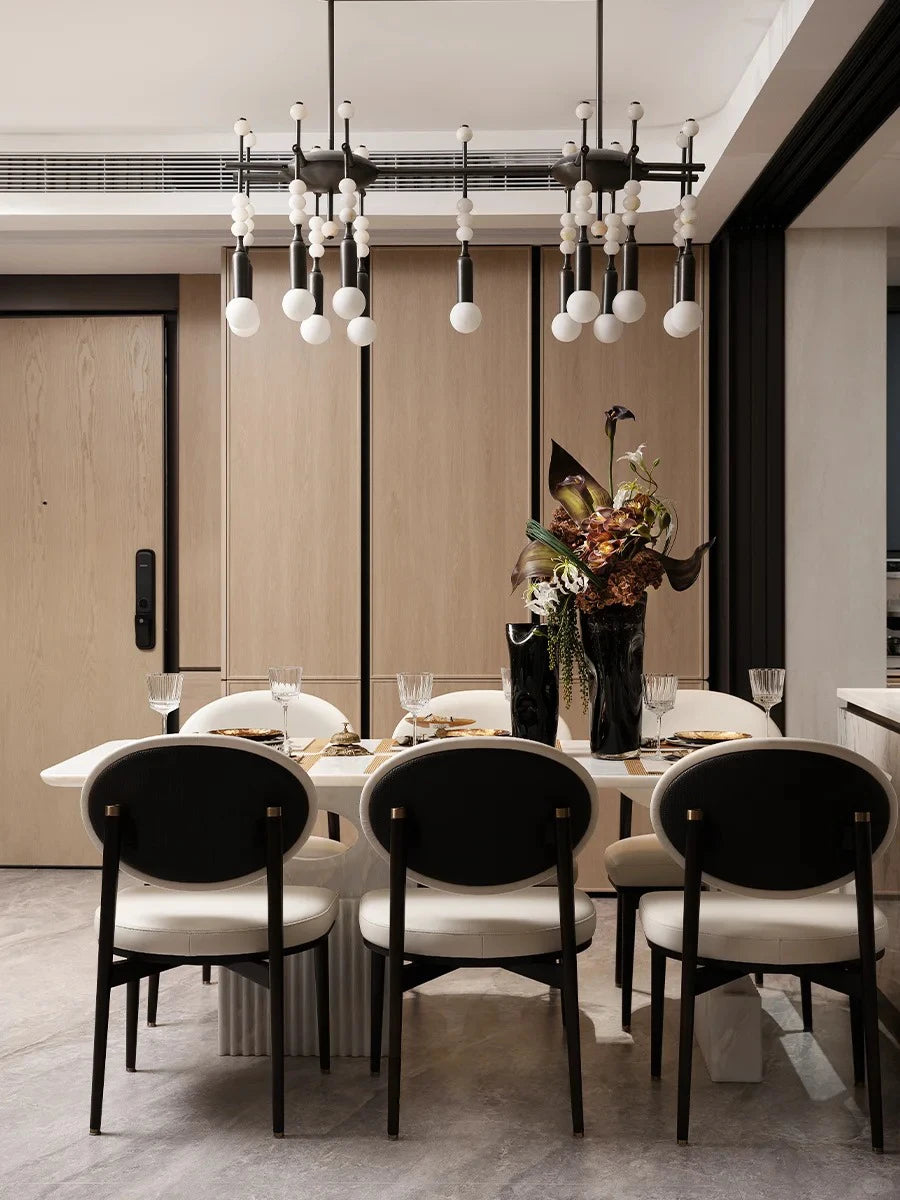 Talisman 14 chandelier hanging above dining table in contemporary interior