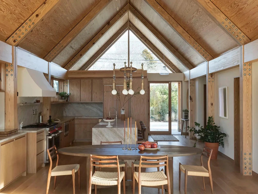 Talisman 8 chandelier above dining table in modern interior lighting setup